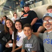 family smiling and watching the football game